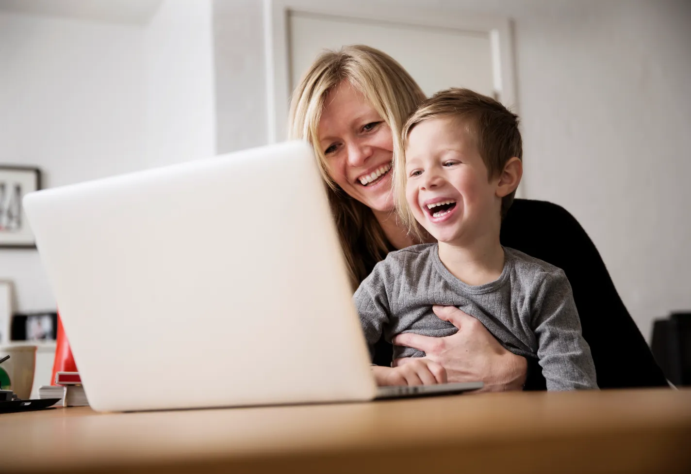 Mother and son viewing information on a laptop. 